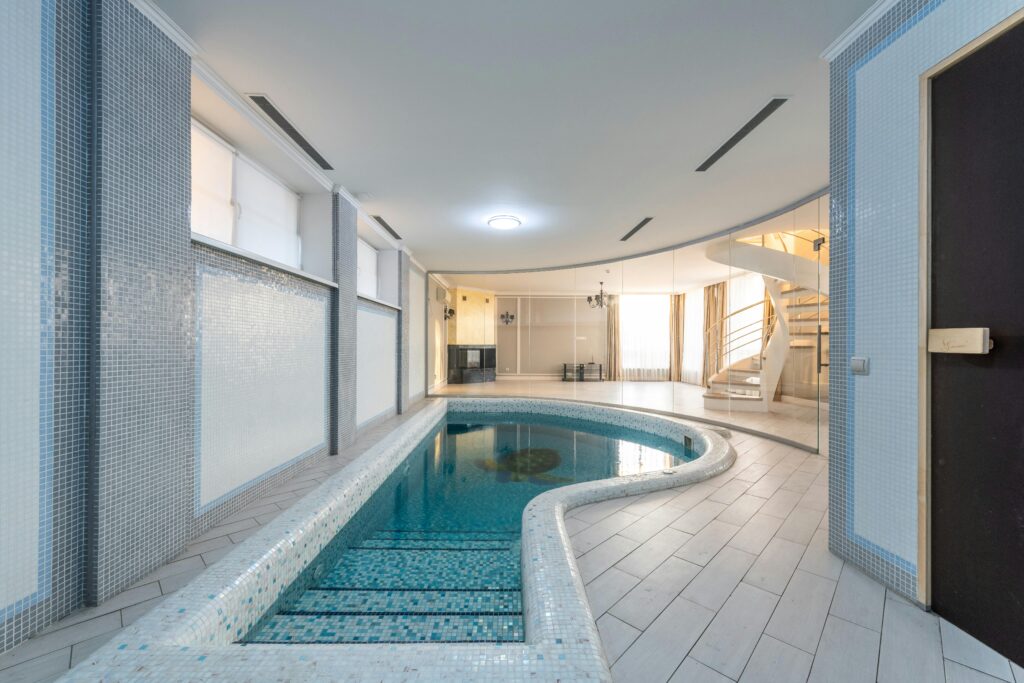 Ventes Serene indoor pool area with modern design and spiral staircase.